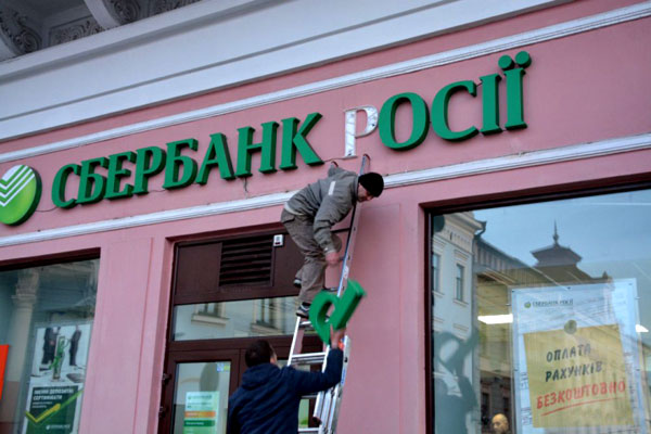 Боевики «Правого сектора» демонтируют вывеску Сбербанка РФ